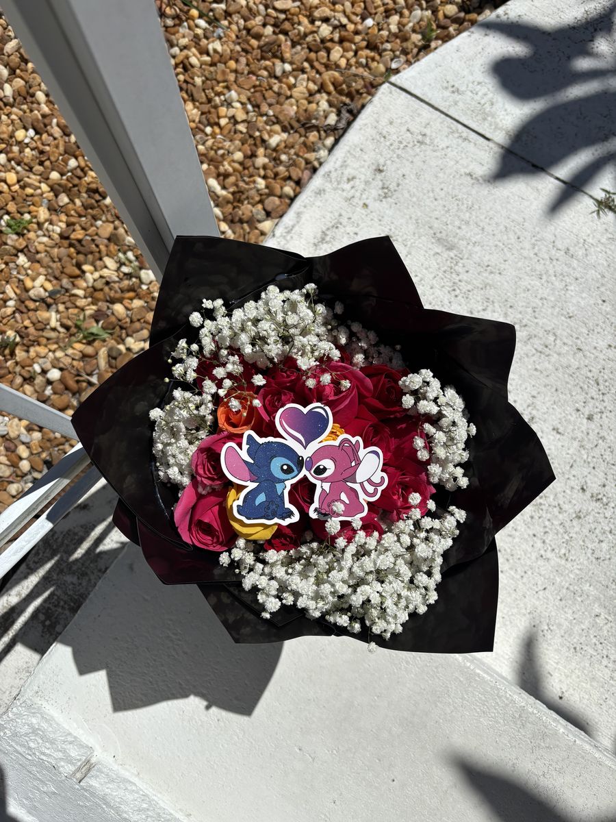 Red rose bouquet with a Stitch topper and baby's breath